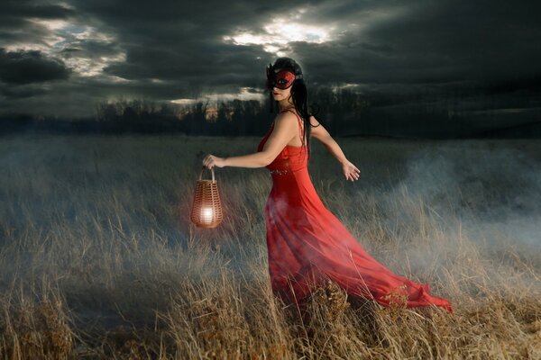 A girl in a red dress against a forest background