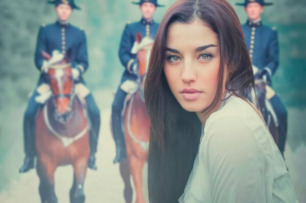 Portrait of a girl against the background of soldiers on horseback