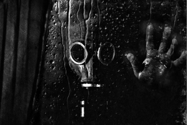 Photo of a man in a gas mask behind a glass cb