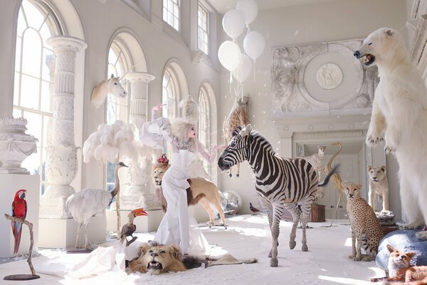 A girl in a zoo museum touches animals