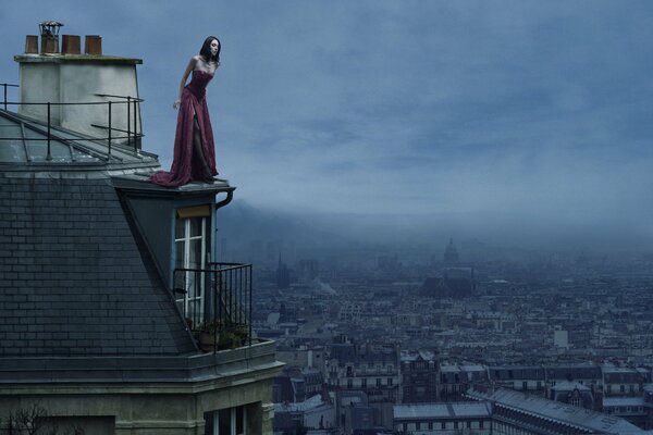 City, house roof, height beautiful girl in evening dress