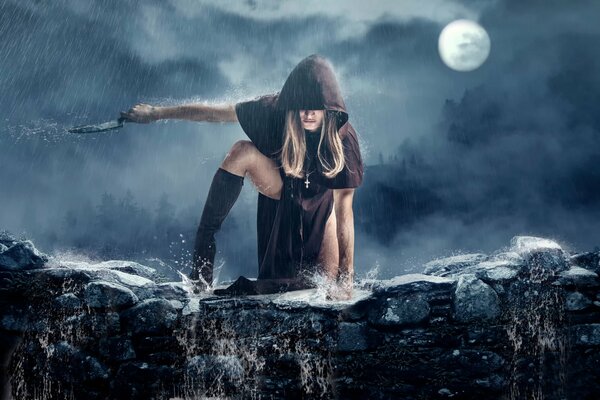 A girl in a raincoat dances with a knife under the moon