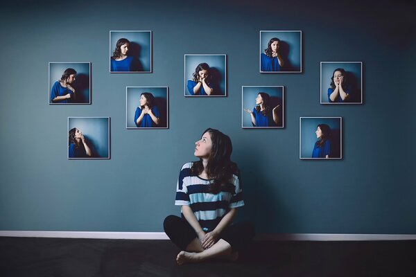 A girl on the background of a wall with portraits