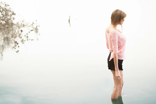 Girl in black shorts in the water