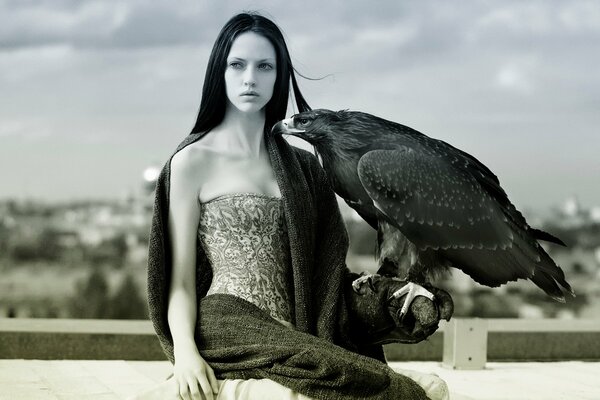 Beautiful girl with a big black bird