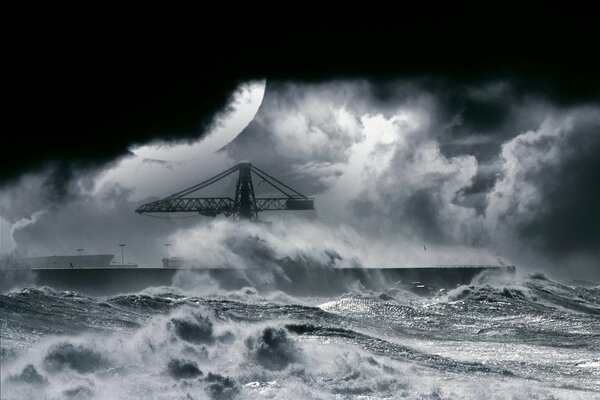 Night storm at the pier with a crane on the pier