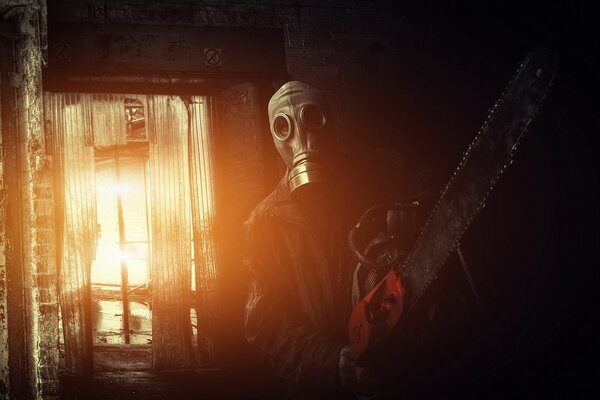 A man on fire in a gas mask with a chainsaw