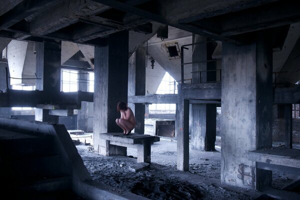 Naked girl in an abandoned building