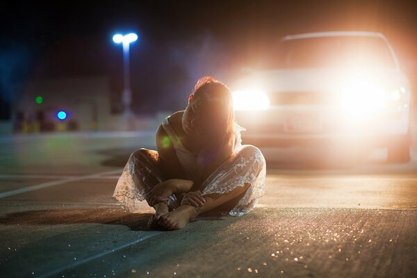 Upset girl almost committed suicide by sitting on the road under a car