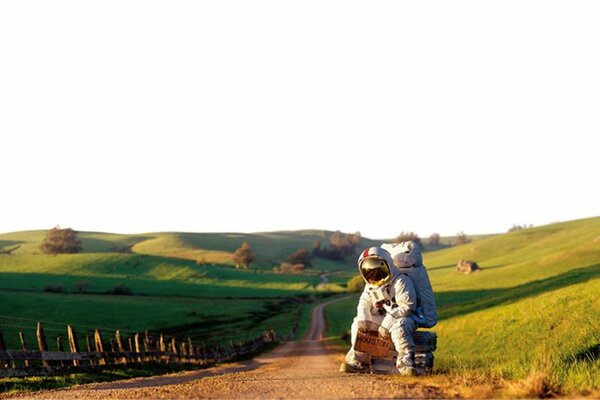 The astronaut stopped in the green mountains