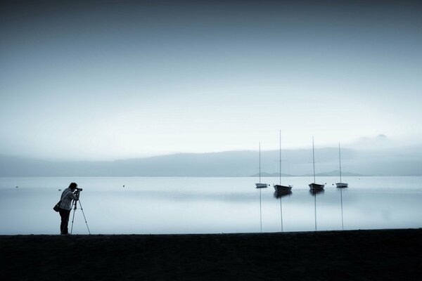 Fotógrafo fotografiando barcos en el lago