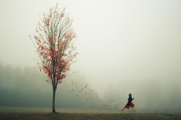 Girl and autumn tree and leaves