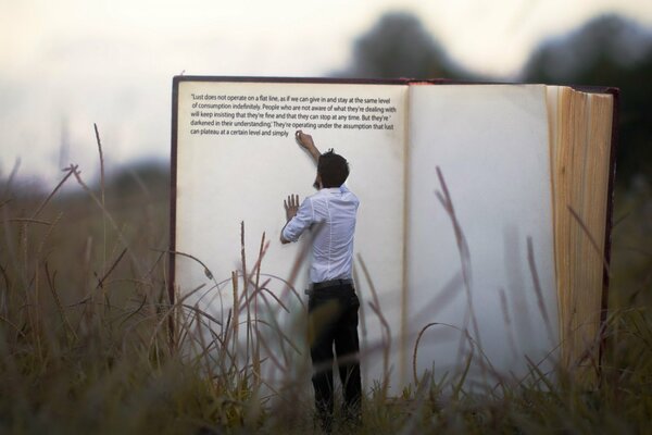 Picture of a man at a huge book