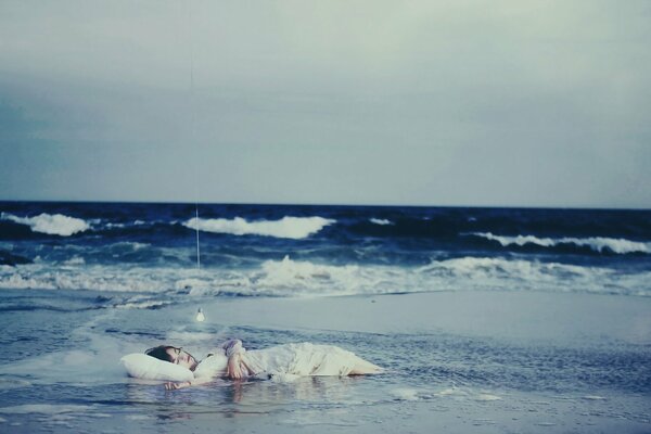 Photo of a boy sleeping in the sea waves