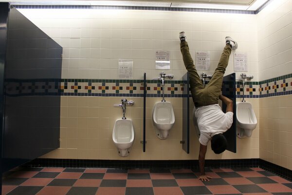 A man in the toilet upside down