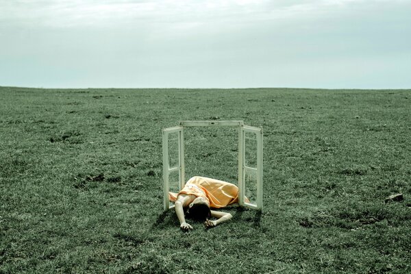 Art house photo, open shutters of a window in a field with a girl in it