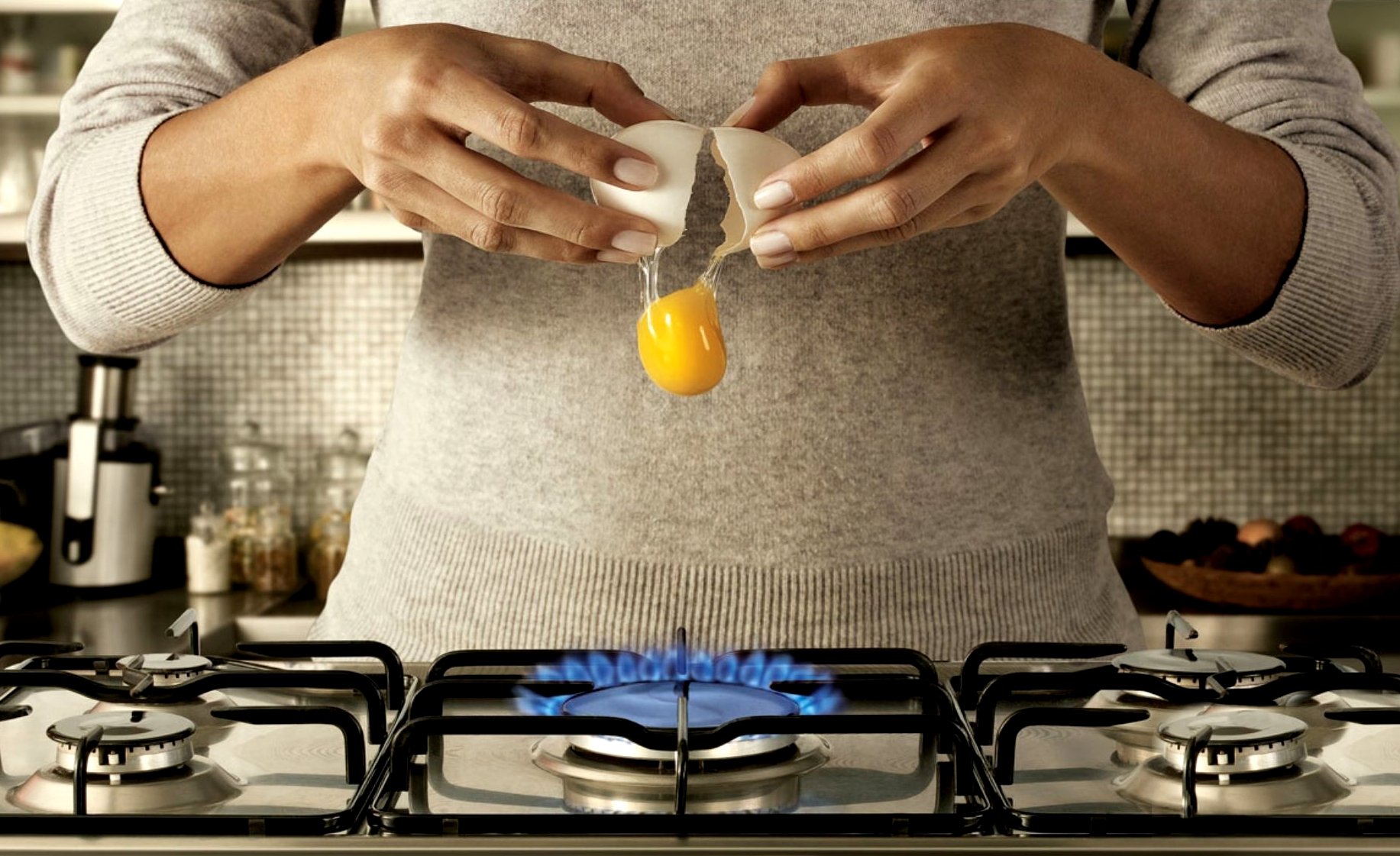 les mains le gaz plaque de cuisson brisé l oeuf le jaune d oeuf le mouvement