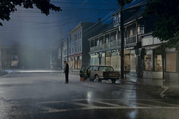 Sad man at dusk alone by the car