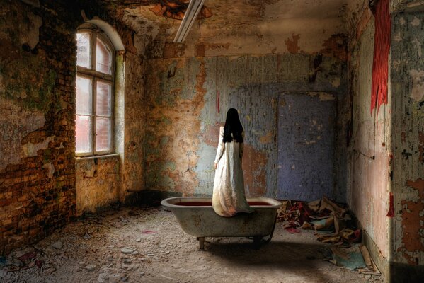 Girl in the bathroom in an abandoned building