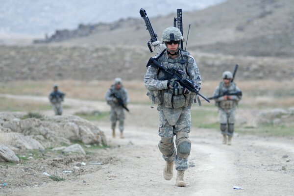 A US military soldier carries cargo and weapons