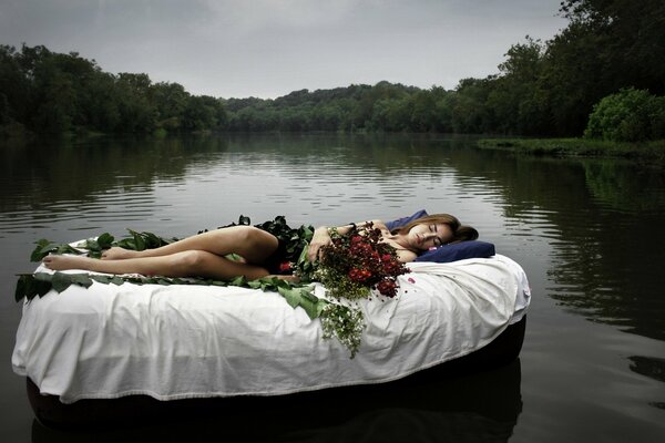 A girl on an inflatable mattress floats on the lake