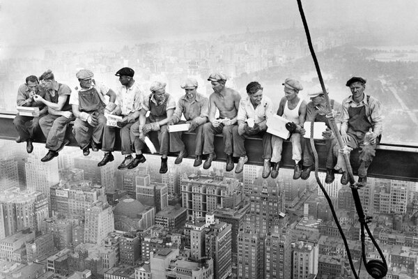 With a lunch break. Workers smoke on the beam