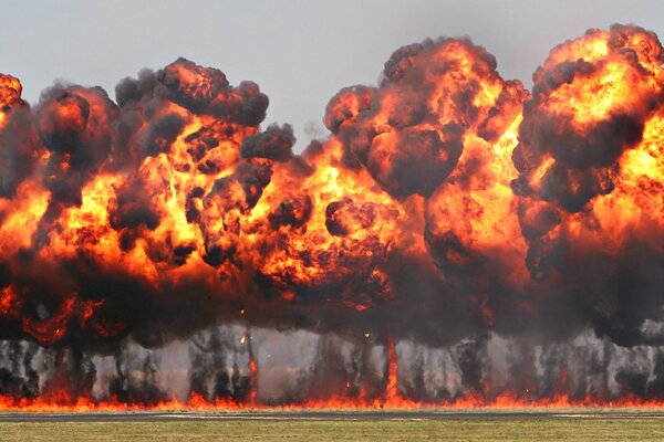 Un campo verde envuelto en una enorme explosión y un incendio