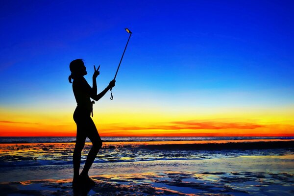 Sunset on the sea. Girl. Selfie