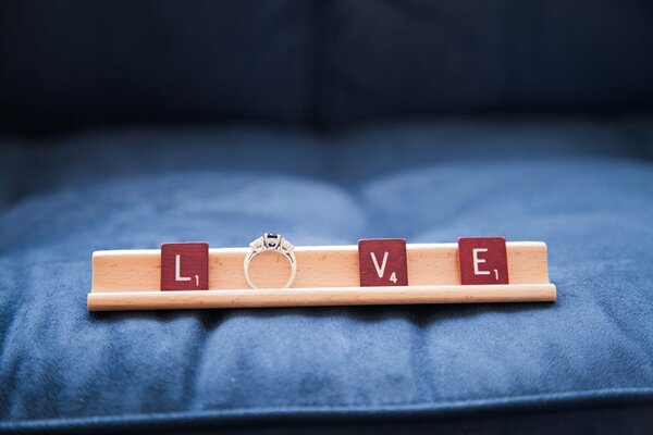 The ring lies beautifully instead of a letter in the word love