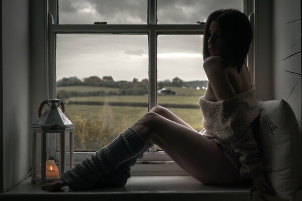 Girl in leggings on the window