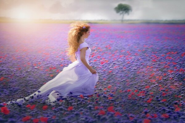 A girl in a white dress runs across the field