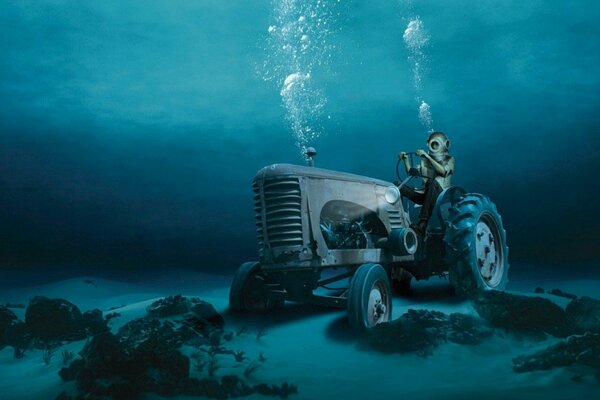 Scuba diver sits on a drowned tractor