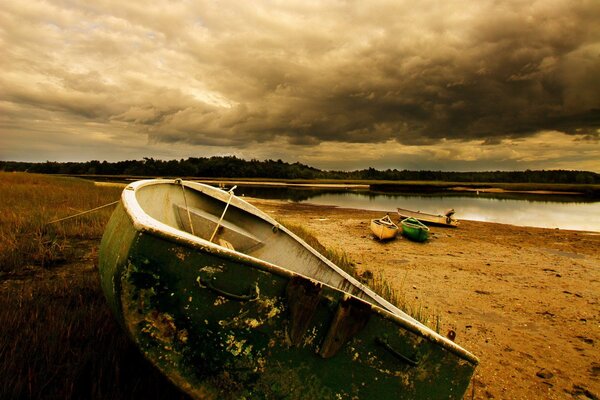 A dim shore with a boat and a river