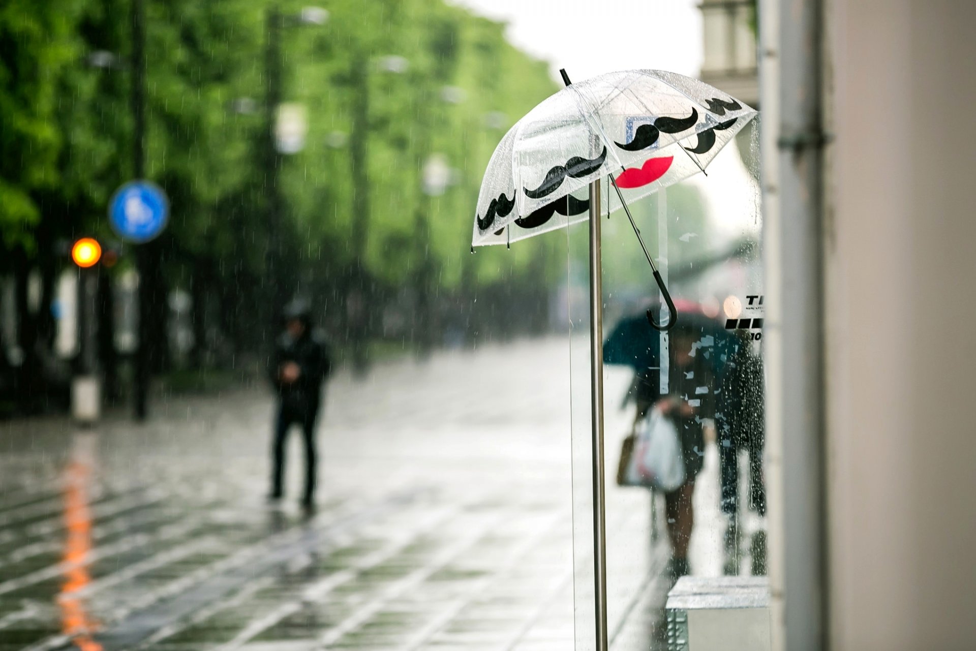 umbrella umbrella rain street passers-by people shops city