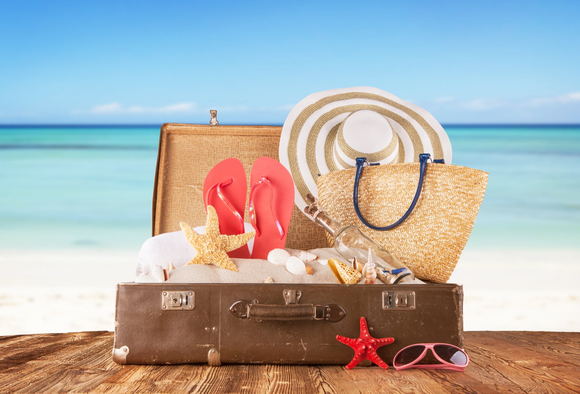 ea boards suitcase sand bottle shells slates hat bag glasse