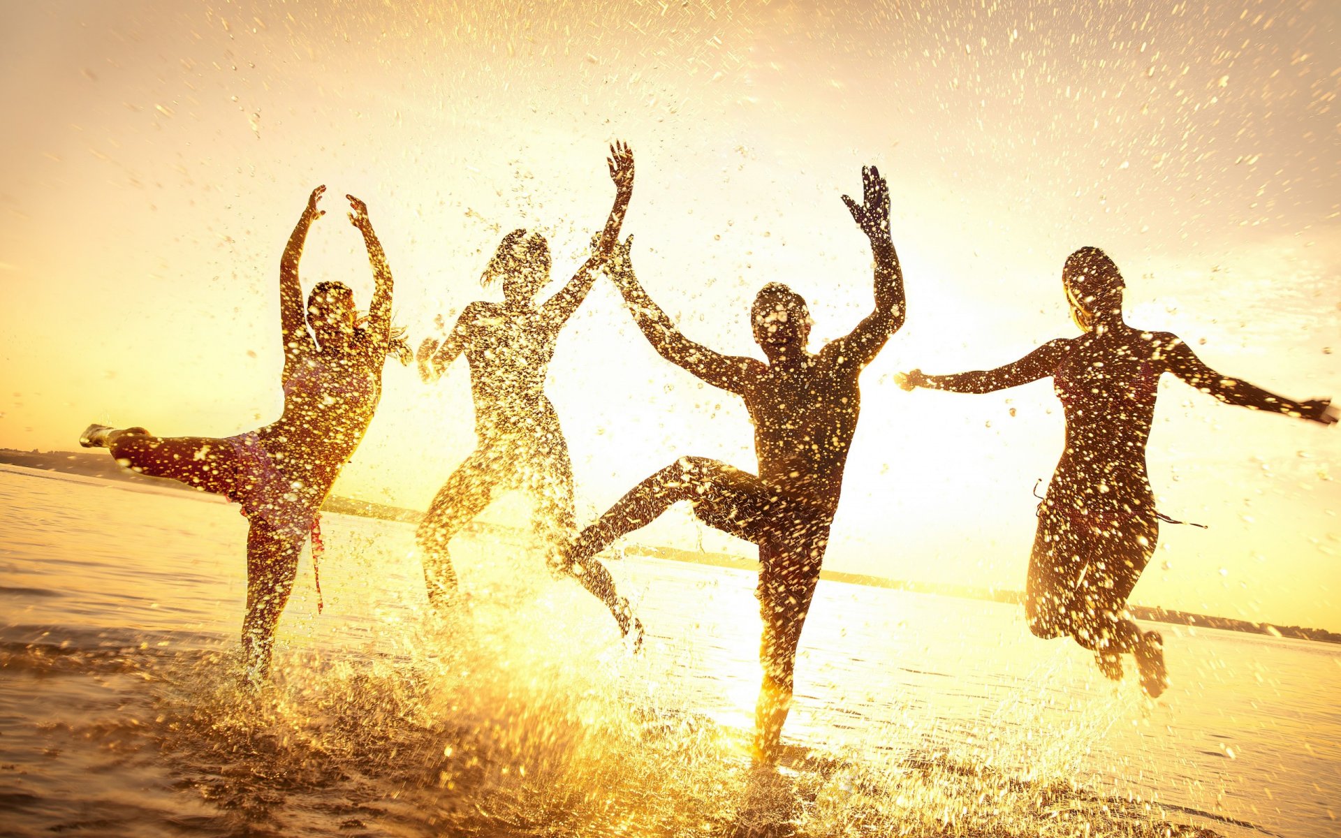 people the group summer water drops spray happiness girls jump horizon sky dawn sunset light rays silhouettes outline figure