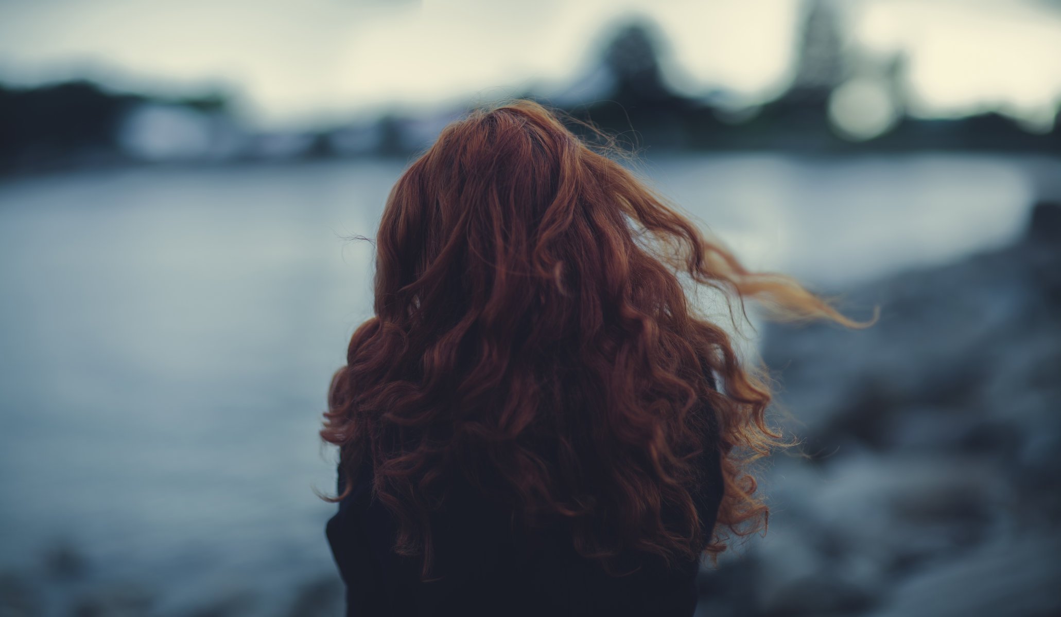 girl locks hair bokeh close up wind