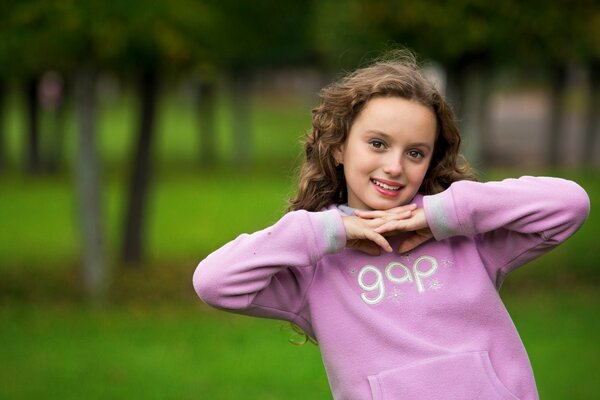 Portrait of a girl on a background of greenery