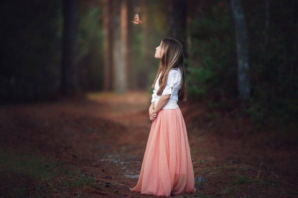 Lonely beautiful girl in the forest