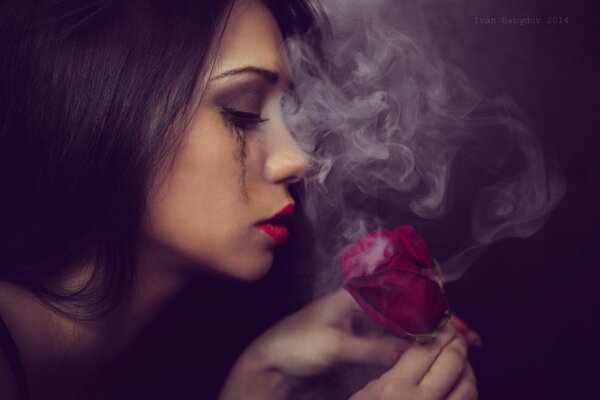 Photo of a sad girl with a rose