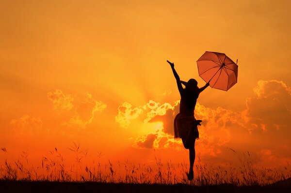 A girl with an umbrella in the sunset