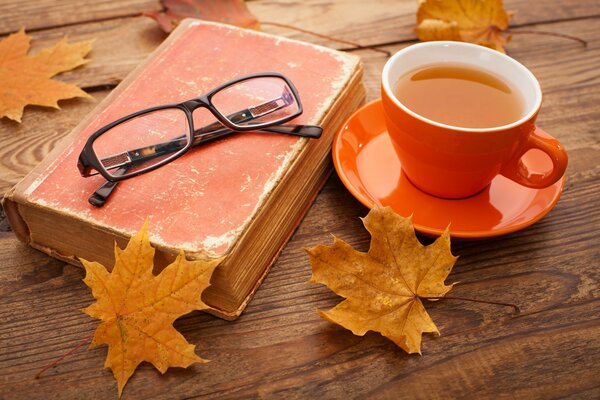 Herbst, Laubfall, eine Tasse Tee auf dem Tisch