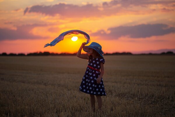 Girls and the setting sun in the field