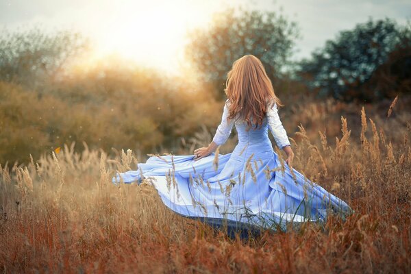 Chica mágica en un vestido en la naturaleza