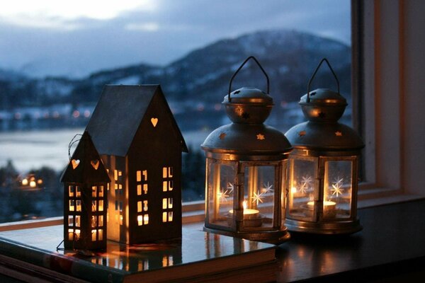 New Year candlesticks on the window with mountain view