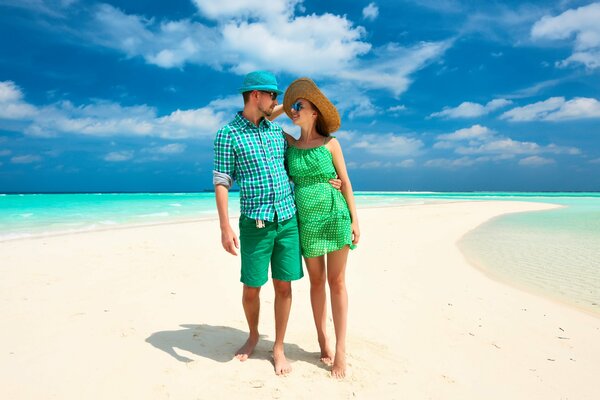 Couple strolling along the beach in the tropics