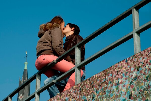 A kiss of a guy and a girl on the background of a temple