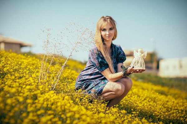 The girl is holding an unusual doll in her hands