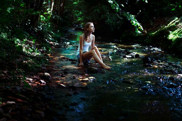 Sad girl in the shade of trees