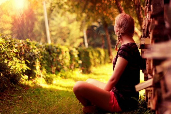 A girl by a tree on a wonderful summer day